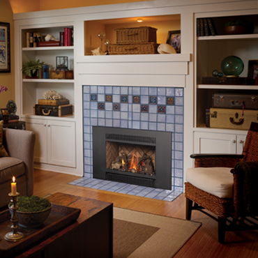 fireplace insert with fire burning. Hearth that surrounds it is light blue with some checkerboard patterns. Bookshelves to the right and left of it and chairs and table in the room