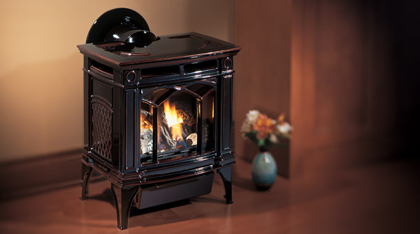 small black stove with fire burning in it.