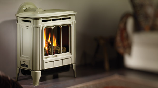 off white wood stove with fire burning rest of background images in photo blurred