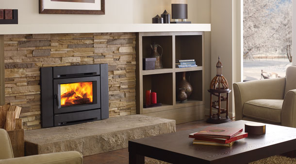 black fireplace insert with fire burning and brick hearth background. book shelves to the right and table and chairs in room