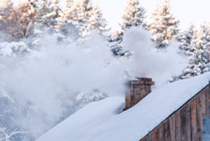 chimney burning with snow on roof