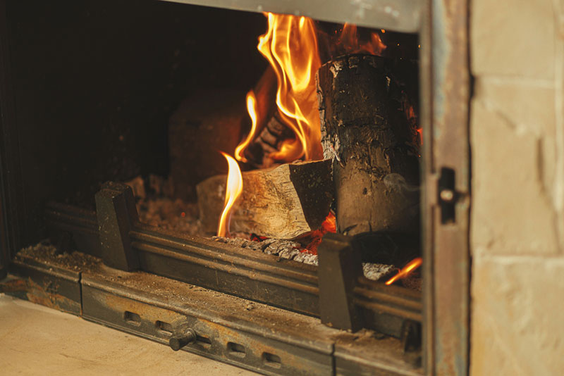 Burning firewood in a rustic fireplace